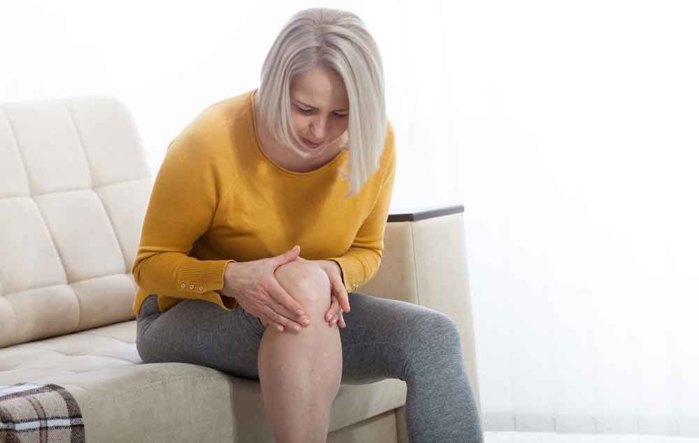 Woman Examines Her Knee