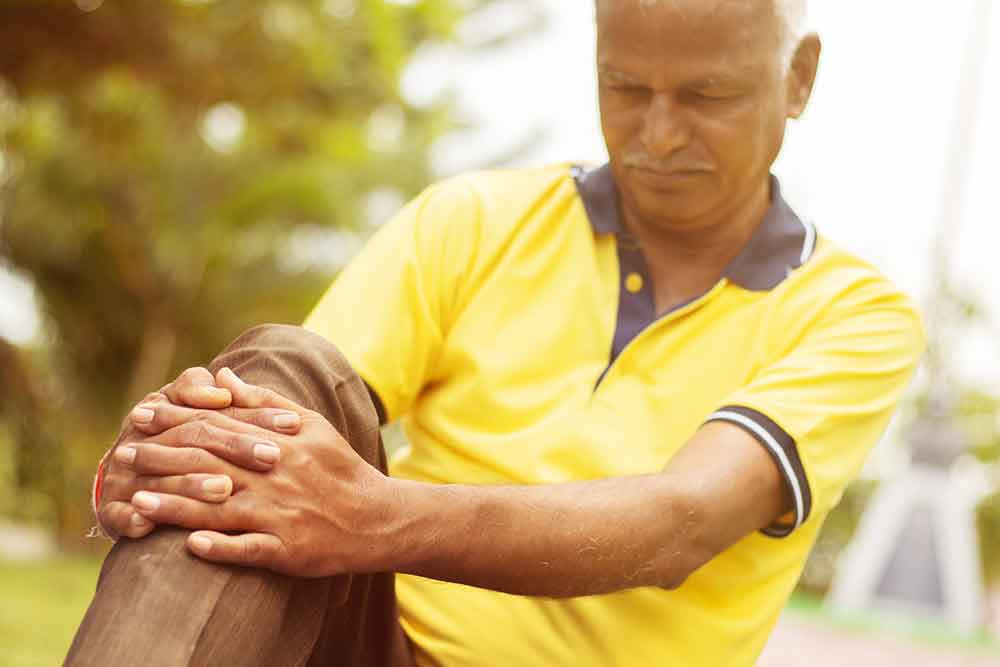 Elderly Man Holding His Knee