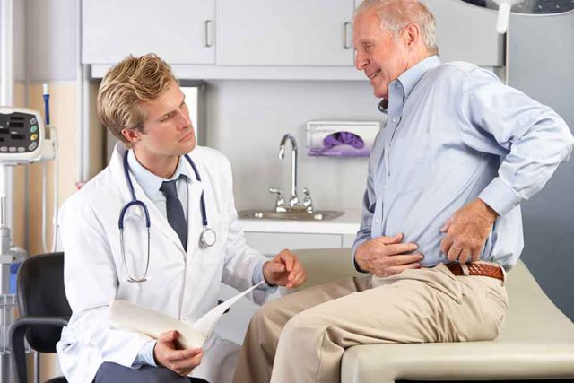 Doctor Examining Man With Hip Pain