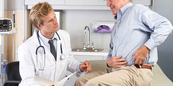 Doctor Examining Man With Hip Pain